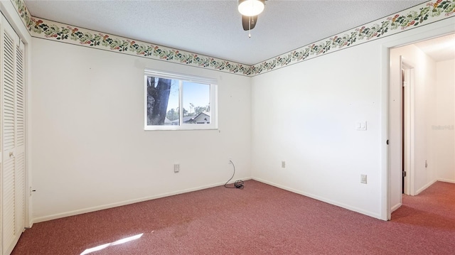 unfurnished bedroom featuring carpet, a closet, baseboards, and a textured ceiling