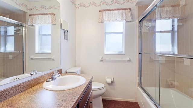 full bathroom with enclosed tub / shower combo, baseboards, vanity, and toilet