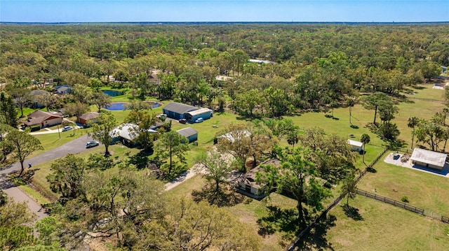 birds eye view of property featuring a wooded view