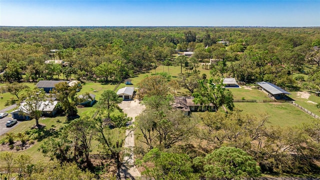 drone / aerial view with a wooded view