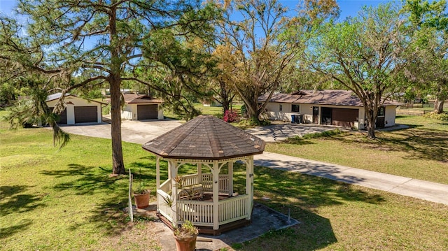 view of yard featuring driveway and a gazebo