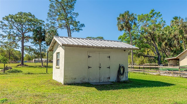 view of shed featuring fence