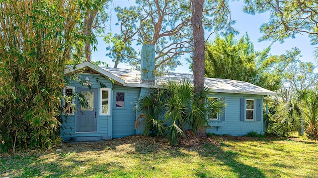 back of house with a lawn