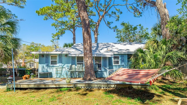 rear view of house featuring a lawn