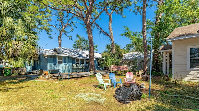 view of yard with a fire pit and fence