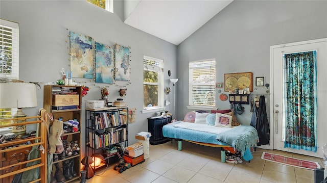 living area featuring tile patterned flooring and high vaulted ceiling