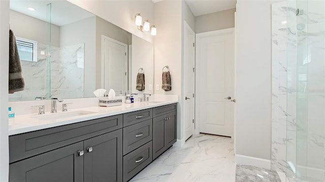 bathroom featuring marble finish floor, baseboards, a sink, and a marble finish shower