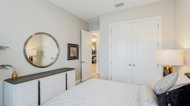 bedroom with a closet and visible vents