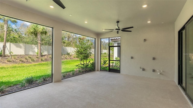 unfurnished sunroom with a ceiling fan