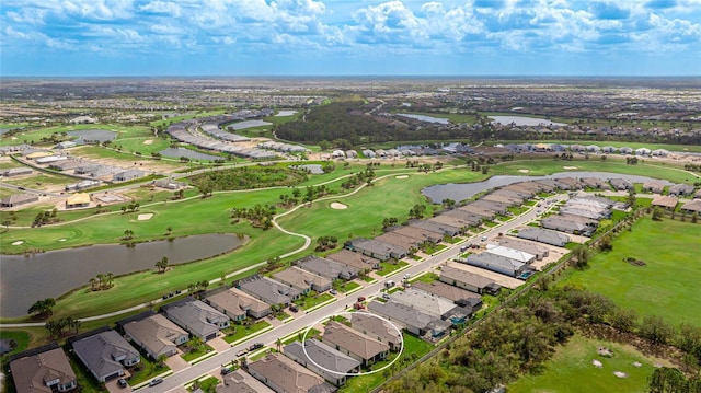 birds eye view of property featuring view of golf course, a water view, and a residential view