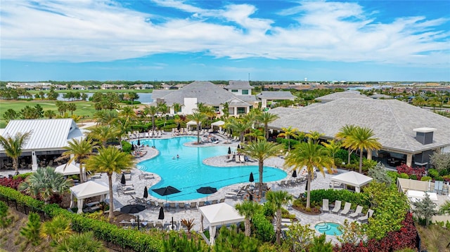 community pool with a residential view and a patio