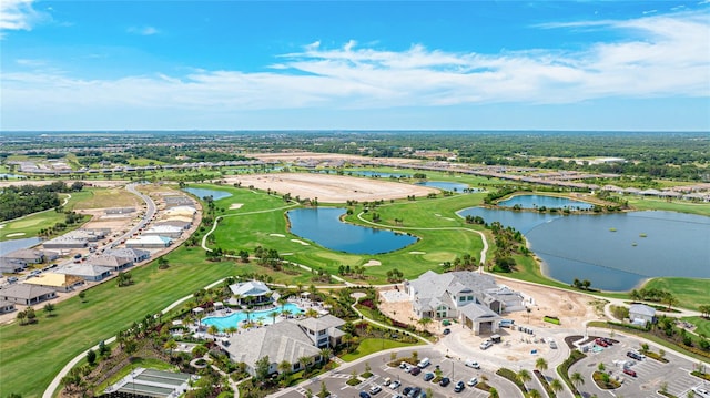 view of property location with a large body of water, a local golf course, and a pool area