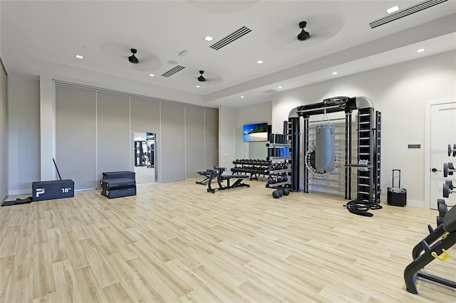 exercise room with recessed lighting and wood finished floors