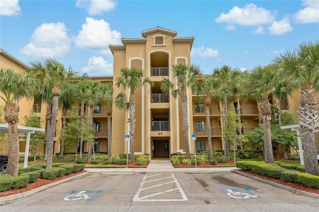 view of property featuring uncovered parking