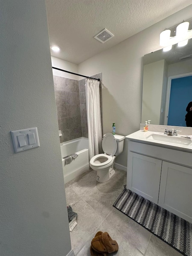 bathroom featuring a textured ceiling, toilet, vanity, visible vents, and shower / bath combination with curtain