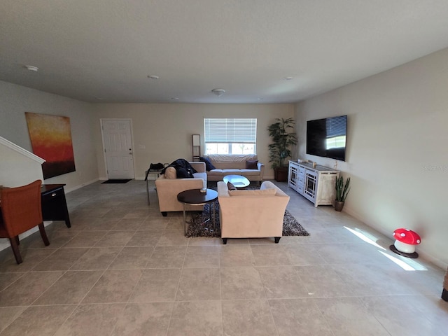 living room featuring light tile patterned floors and baseboards