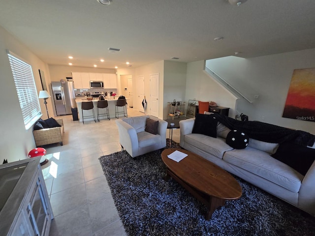 living area featuring light tile patterned flooring and recessed lighting