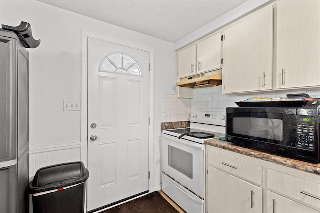 kitchen with under cabinet range hood, white range with electric stovetop, black microwave, and a textured ceiling