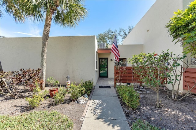 entrance to property featuring stucco siding