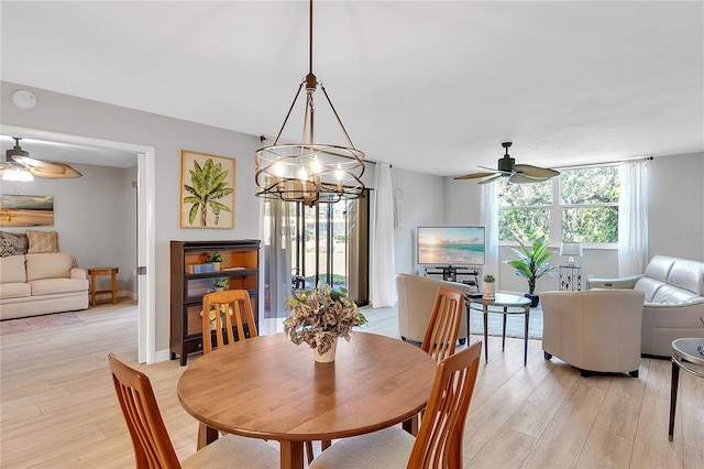 dining room featuring light wood-style floors, ceiling fan, and baseboards