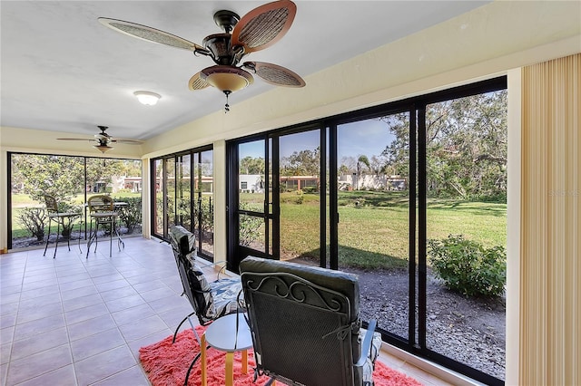 sunroom featuring ceiling fan and a wealth of natural light