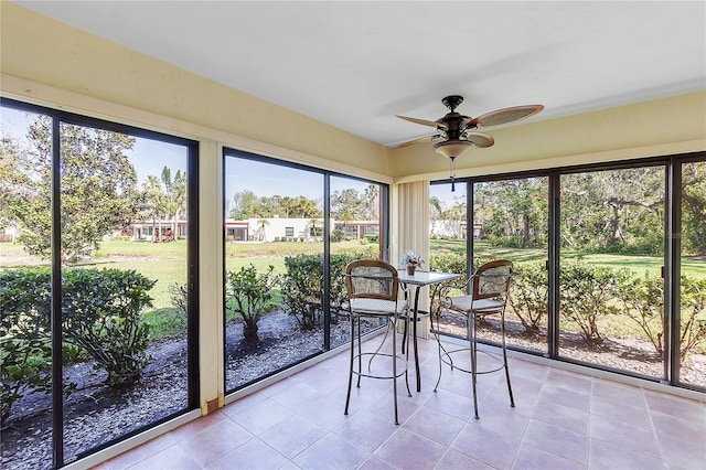 unfurnished sunroom with a ceiling fan