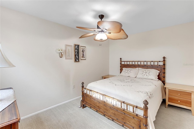 bedroom with light carpet, a ceiling fan, and baseboards