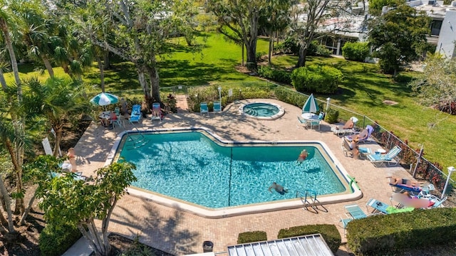 pool featuring a patio area, fence, and a hot tub