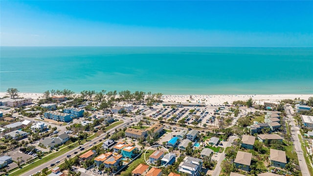 drone / aerial view with a water view, a residential view, and a view of the beach