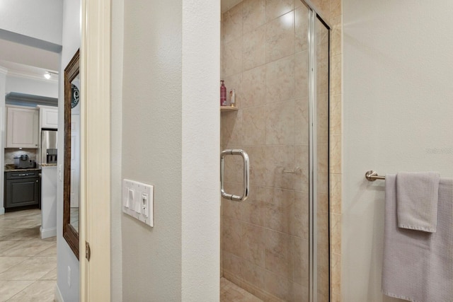 full bath with a stall shower and tile patterned flooring