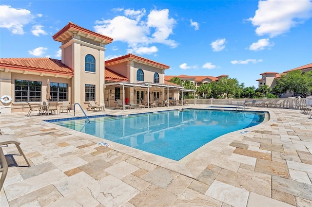pool featuring a patio and fence