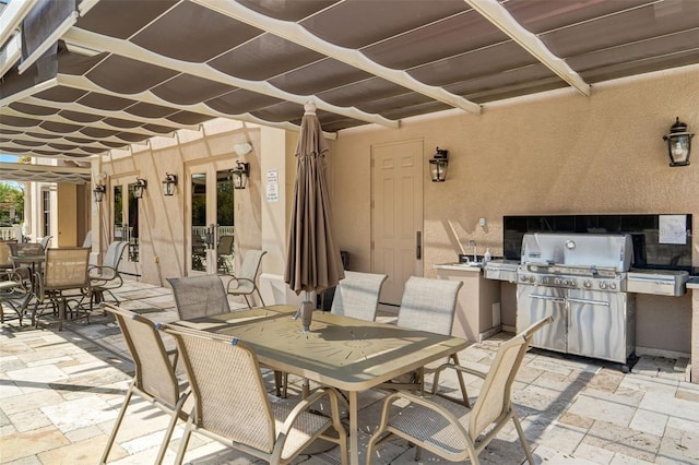 view of patio / terrace with area for grilling, outdoor dining area, french doors, and a grill