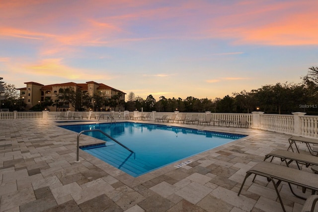 community pool featuring a patio and fence