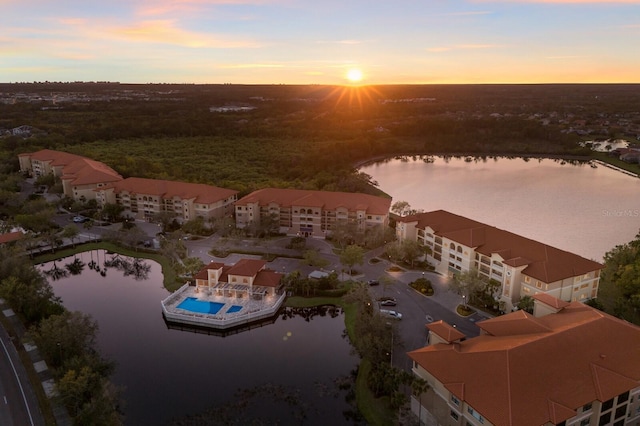 aerial view at dusk with a water view