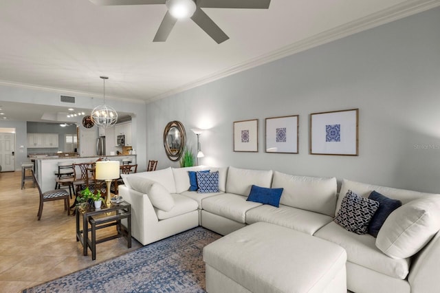 living area featuring light tile patterned floors, ceiling fan with notable chandelier, visible vents, and ornamental molding