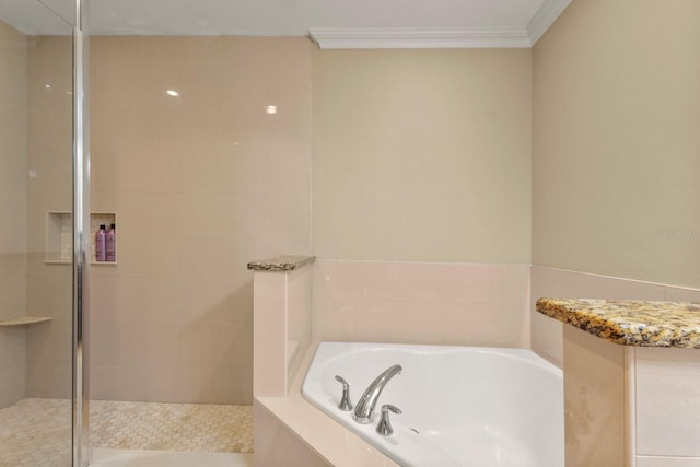 full bathroom featuring crown molding, a bath, and a tile shower