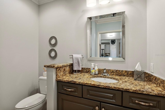 bathroom featuring toilet and vanity