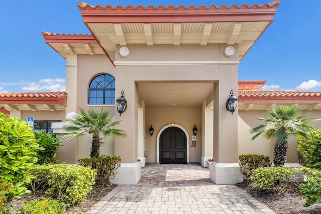 property entrance with stucco siding