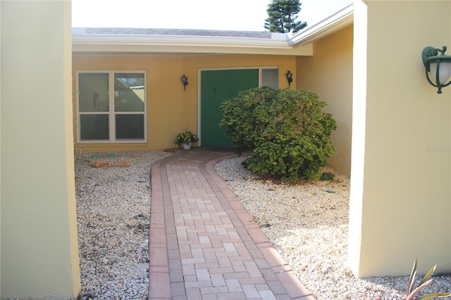 entrance to property with stucco siding