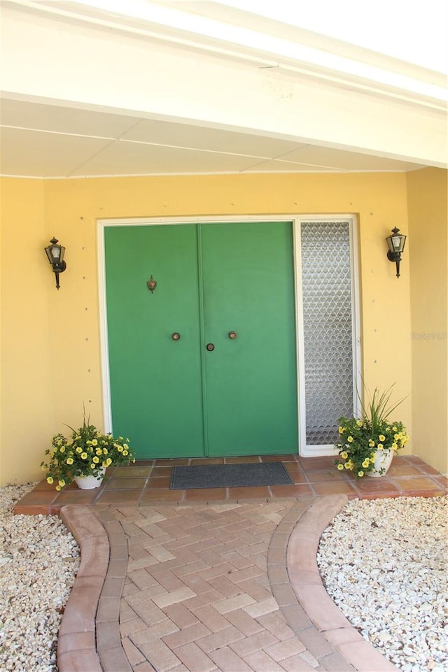 property entrance with stucco siding