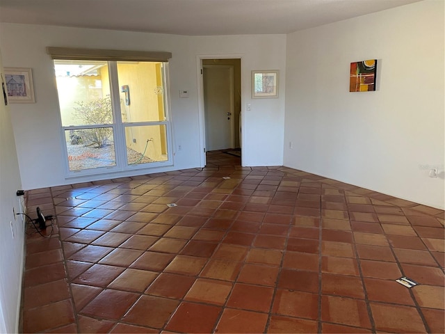 unfurnished room featuring tile patterned flooring