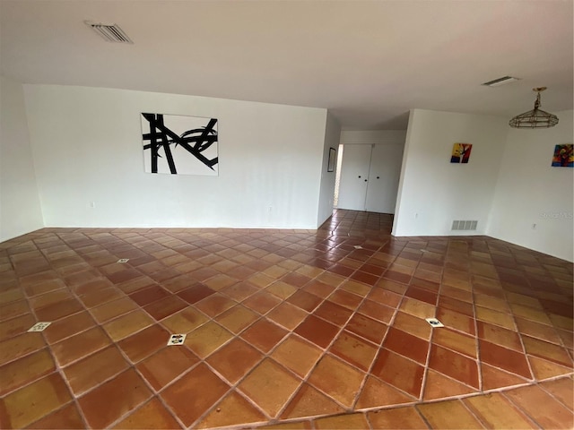 tiled spare room with visible vents