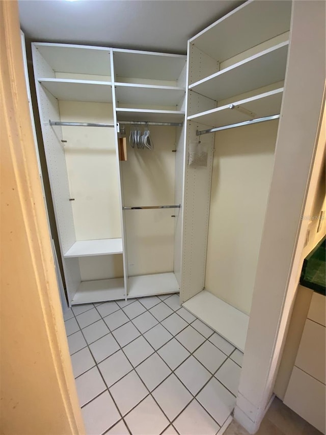 walk in closet featuring light tile patterned flooring