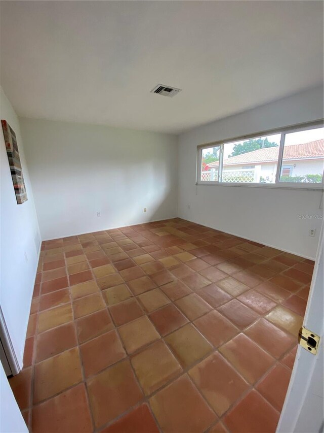 tiled empty room with visible vents