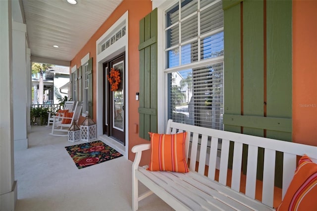 view of exterior entry featuring covered porch