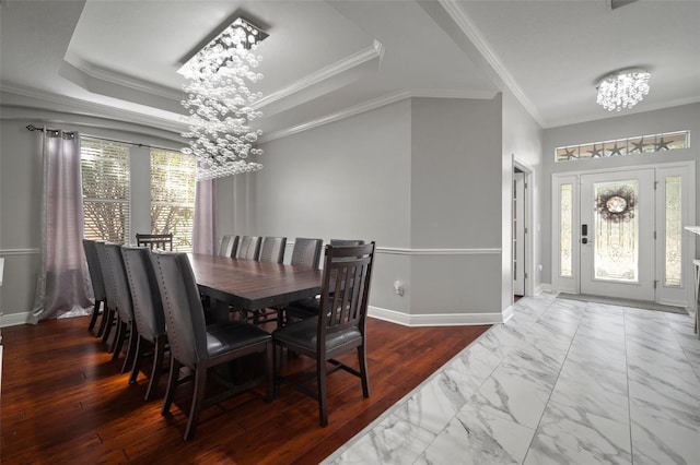 dining space featuring baseboards, an inviting chandelier, a tray ceiling, crown molding, and marble finish floor