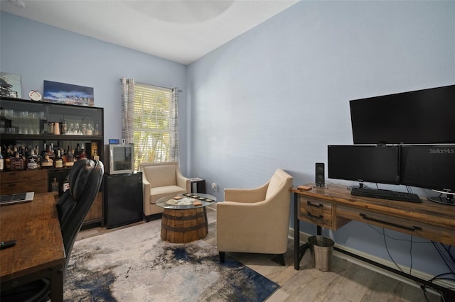 office featuring a bar and wood finished floors