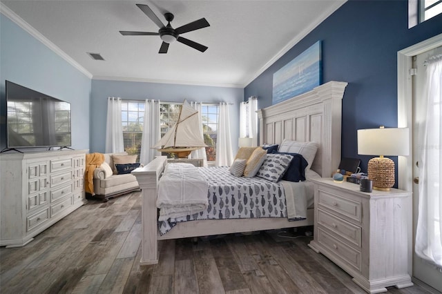 bedroom featuring ceiling fan, visible vents, dark wood finished floors, and crown molding