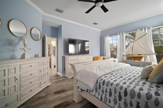 bedroom with crown molding, visible vents, and dark wood-style flooring