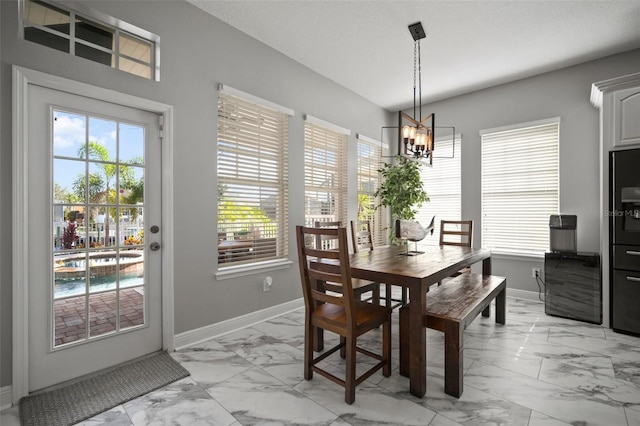 dining area with plenty of natural light and marble finish floor